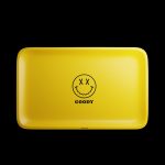 A top-down view of the Goody Glass Yellow Big Face Rolling Tray, featuring a large circular graphic on a yellow surface.