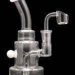 Clear glass dab rig with a quartz banger and colorful accents.