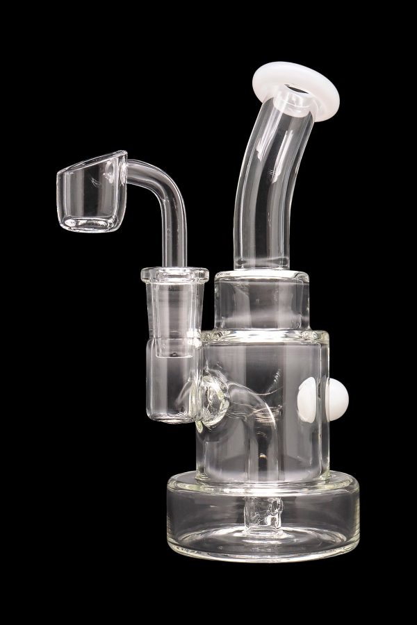 Clear glass dab rig with quartz banger, isolated on a black background.