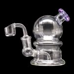 Clear glass dab rig with spherical chamber and quartz banger.
