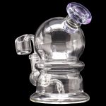 Clear glass dab rig with quartz banger, isolated on a black background.