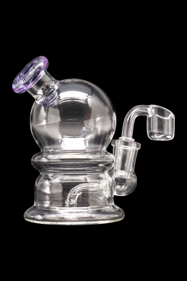 Clear glass water pipe (rig) with a quartz banger, isolated on a black background.