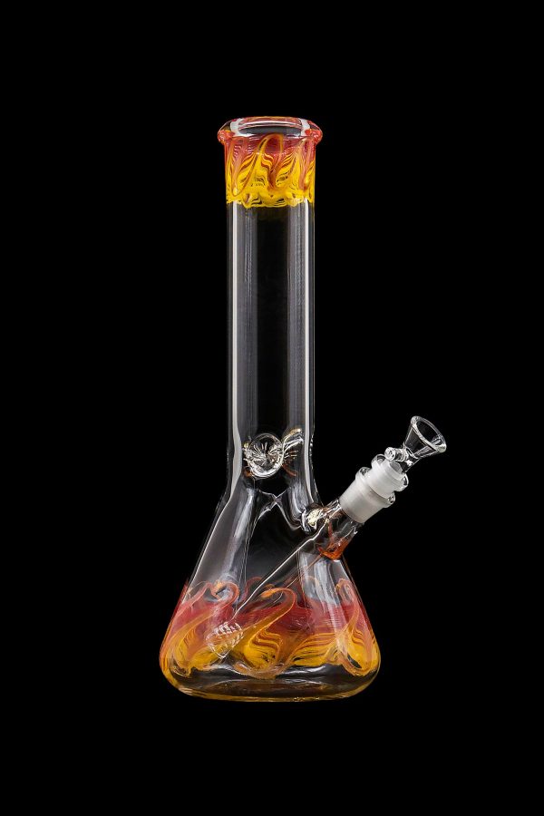 A glass bong with orange and yellow swirls, isolated on a black background.
