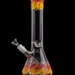Glass bong with orange and red swirl patterns against a black background.