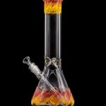 Glass water pipe with orange and yellow swirling patterns, isolated on a black background.