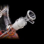 Clear glass bong with orange accents and a detachable bowl piece.