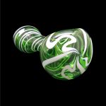 Green and white swirled glass pipe against a black background.