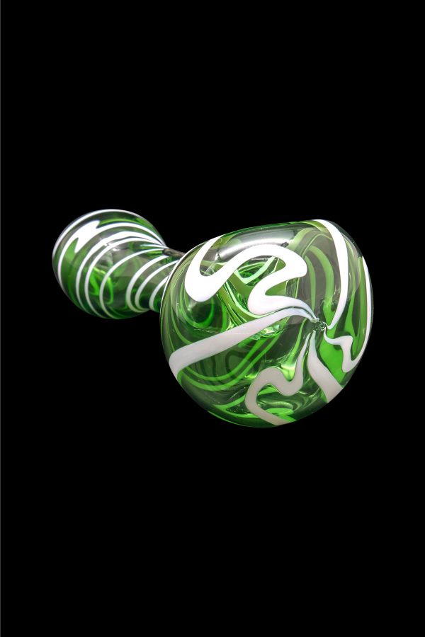 Green and white swirled glass pipe against a black background.