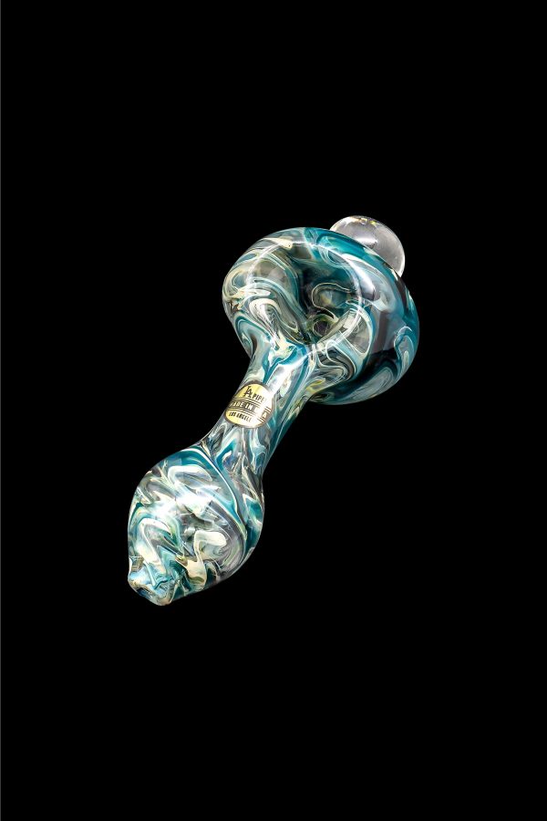 Hand-blown glass pipe with teal and gold swirls, isolated on a black background.