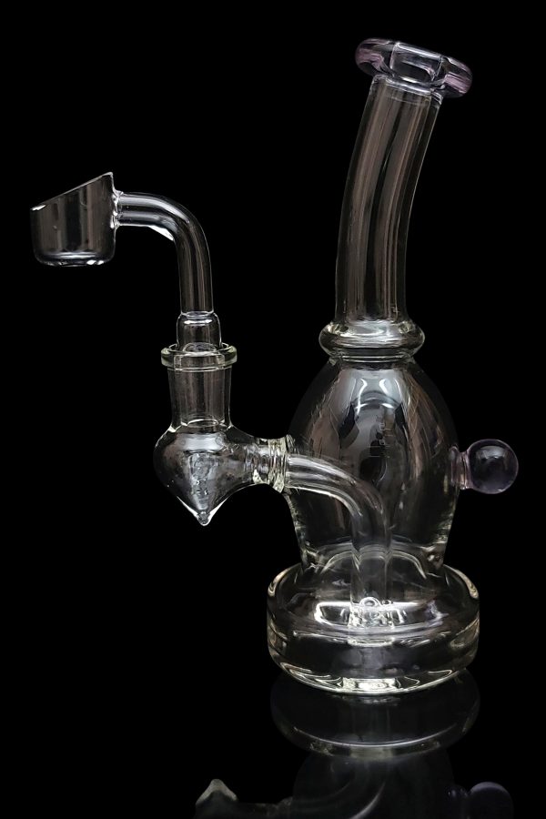Clear glass dab rig with a quartz banger, isolated on a black background.