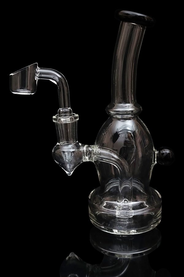 Clear glass dab rig with a quartz banger, isolated on a black background.
