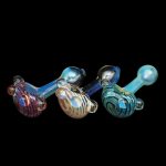 Hand-blown glass pipes in vibrant red, blue, and gold hues against a black background.