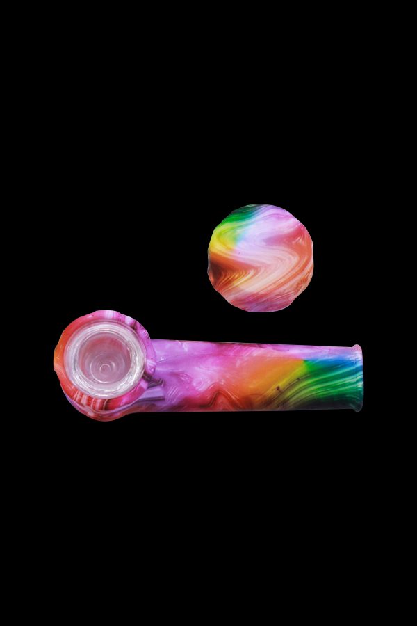 Colorful silicone cannabis pipe and cap against a black background.