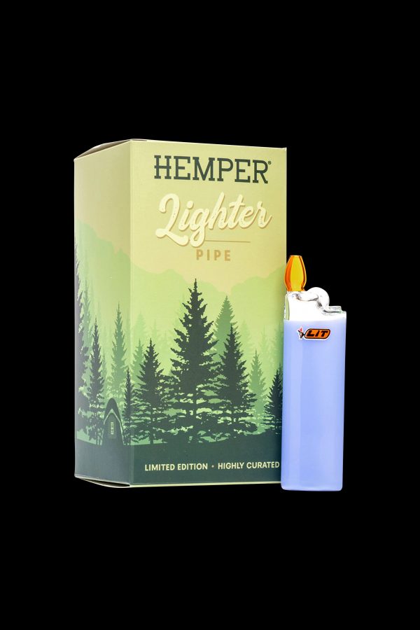 A limited edition “Hemper” lighter pipe box featuring a forest scene, alongside a clear Bic lighter.