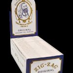 A front view of the Zig Zag White Single Wide Rolling Papers - 24 Pack, showing the white packaging with vintage-style branding.