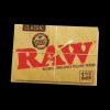 A close-up, angled shot of the RAW Classic 1 1/2" Rolling Papers package against a dark background, highlighting the brand lettering.