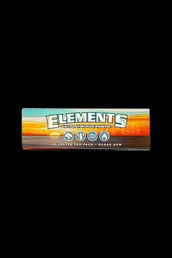 A close-up of the Elements Ultra Thin Rice 1 1/4" Rolling Papers pack, featuring bold branding against a dark background.