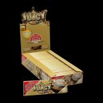 A close-up, angled shot of Juicy Jay's 1 1/4 Chocolate Chip Rolling Papers packaging with a brown and cream color scheme.