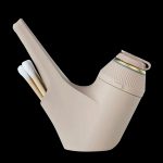 Beige silicone water pipe with a clear glass bowl, isolated on a black background.