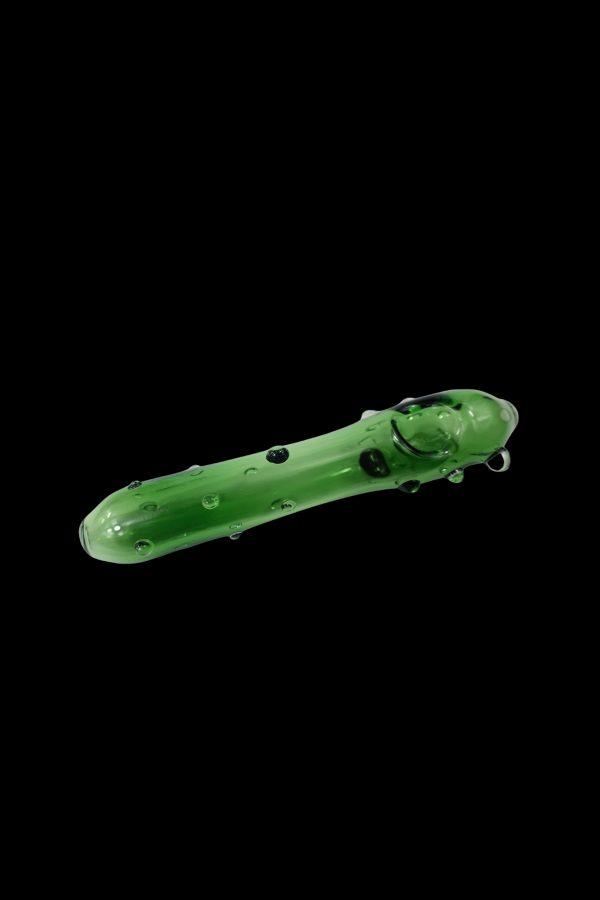 Green glass pipe resembling a pickle against a black background.