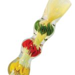 A close-up, angled view of the Rasta Color Fumed Chillum, showing a vibrant, colorful glass design.
