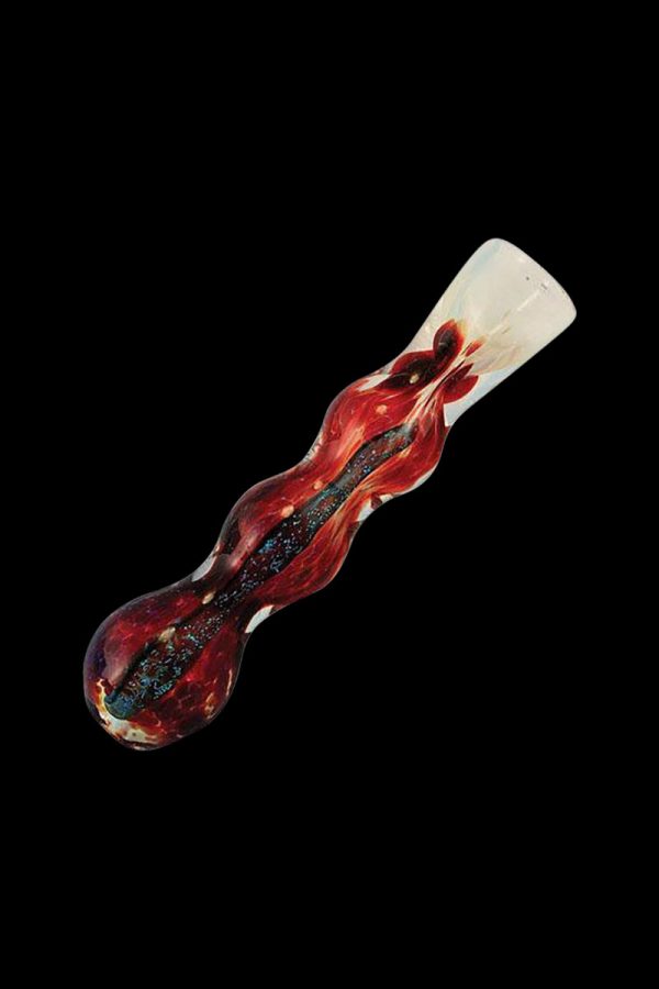A close-up, angled view of the Frit Dichroic Glass Chillum Taster, showcasing its colorful, patterned glass construction.