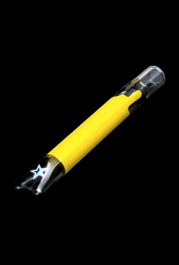 Yellow glass smoking pipe with star-shaped filter visible inside.