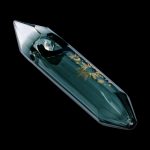 Emerald green glass pipe with gold celestial designs, isolated on black.