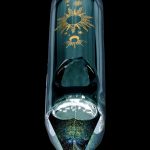 Emerald green glass water pipe with gold celestial designs, featuring a bulbous chamber and pointed mouthpiece, against a black background.