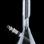 Clear glass bong with ice catch and flared base, reflecting on a black surface.