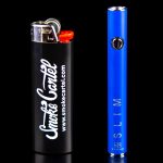 Blue glass pipe and lighter with "Smoke Cartel" branding, reflected on a black surface.