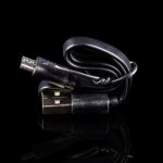 USB charger for a cannabis vape pen, isolated on black.