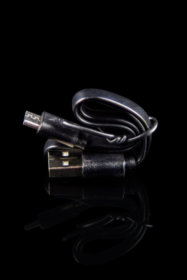USB charger for a cannabis vape pen, isolated on black.