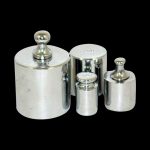 Calibration Weight - 50g displayed as a front view of stacked, cylindrical weights on a dark background.