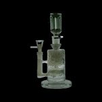 Green glass water pipe (bong) with percolator, studio shot on a black background.