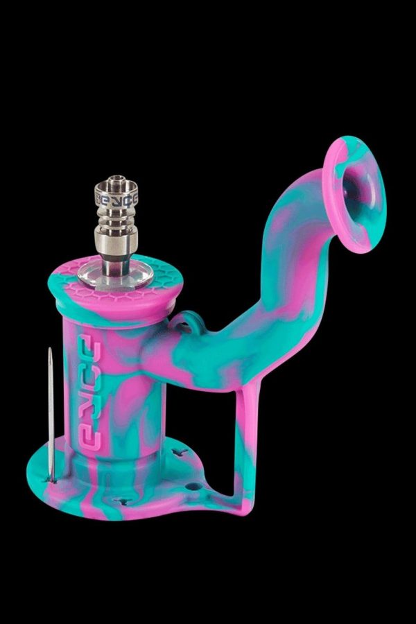 Pink and teal silicone oil rig with a quartz banger and dab tool.