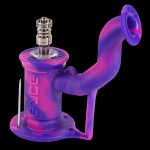 Pink and purple glass water pipe with metal downstem, isolated on a black background.