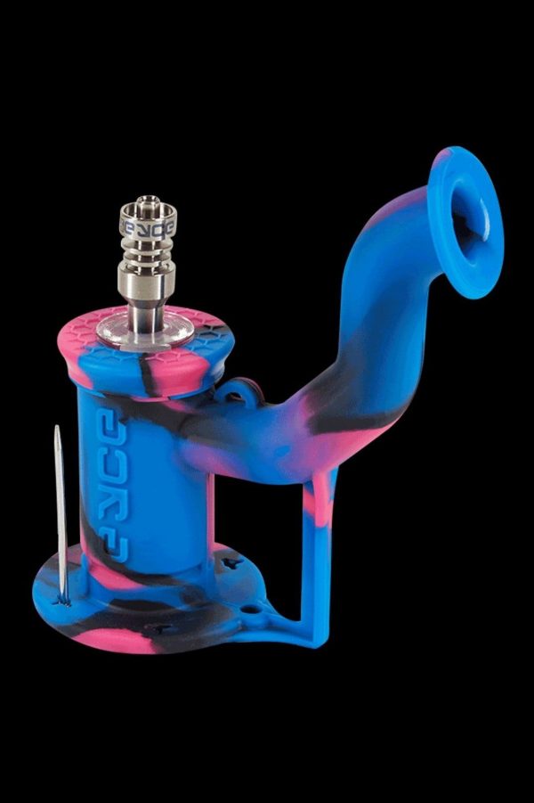 Blue and pink silicone dab rig with a quartz banger and carb cap, isolated on a black background.