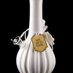 White glass water pipe with a decorative tag reading "My Bud Vase" and a glass bowl, reflected on a black surface.