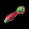 Green and pink glass pipe shaped like a scorpion, isolated on a black background.