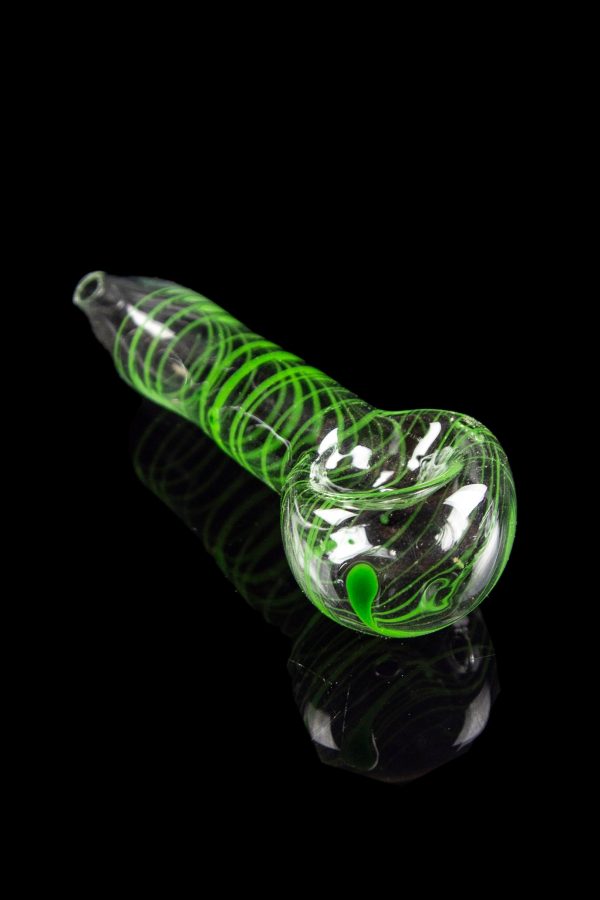 Green glass pipe with swirling patterns, studio shot on a black reflective surface.