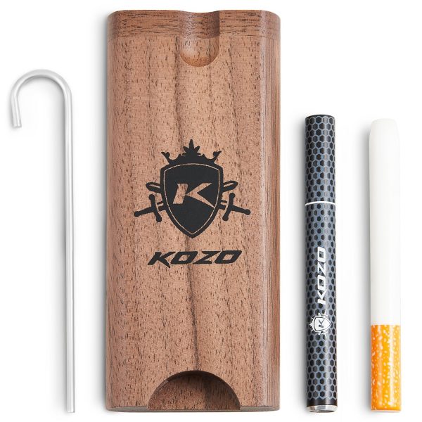 Wooden dugout with a branded logo, a metal packing tool, and a pre-rolled cigarette.