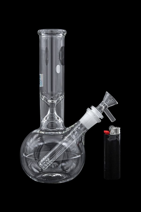 Glass water pipe (bong) and lighter on a black background.