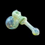 Green and yellow glass bubbler pipe isolated on a black background.