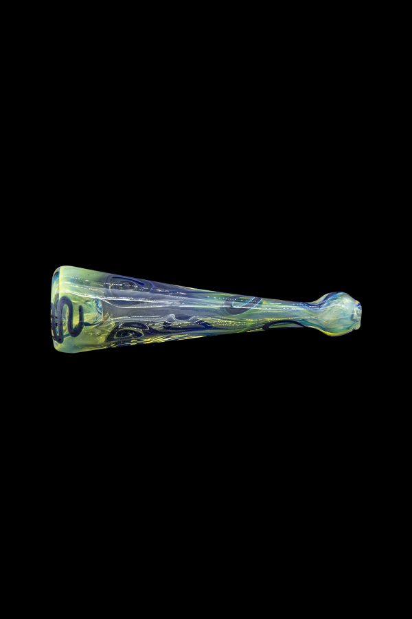 Hand-blown glass cannabis pipe with swirling green and yellow patterns, isolated on a black background.