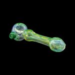 Green glass pipe with swirling patterns against a black background.