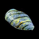 Hand-blown glass cannabis pipe with intricate green, blue, and white patterns.