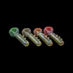 Assortment of colorful glass smoking pipes on a black background.