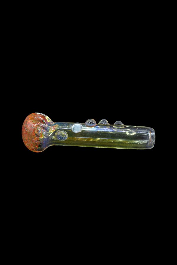 Hand pipe with iridescent green glass and a red and orange marbled bowl, isolated on a black background.