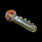 Iridescent glass smoking pipe against a black background.